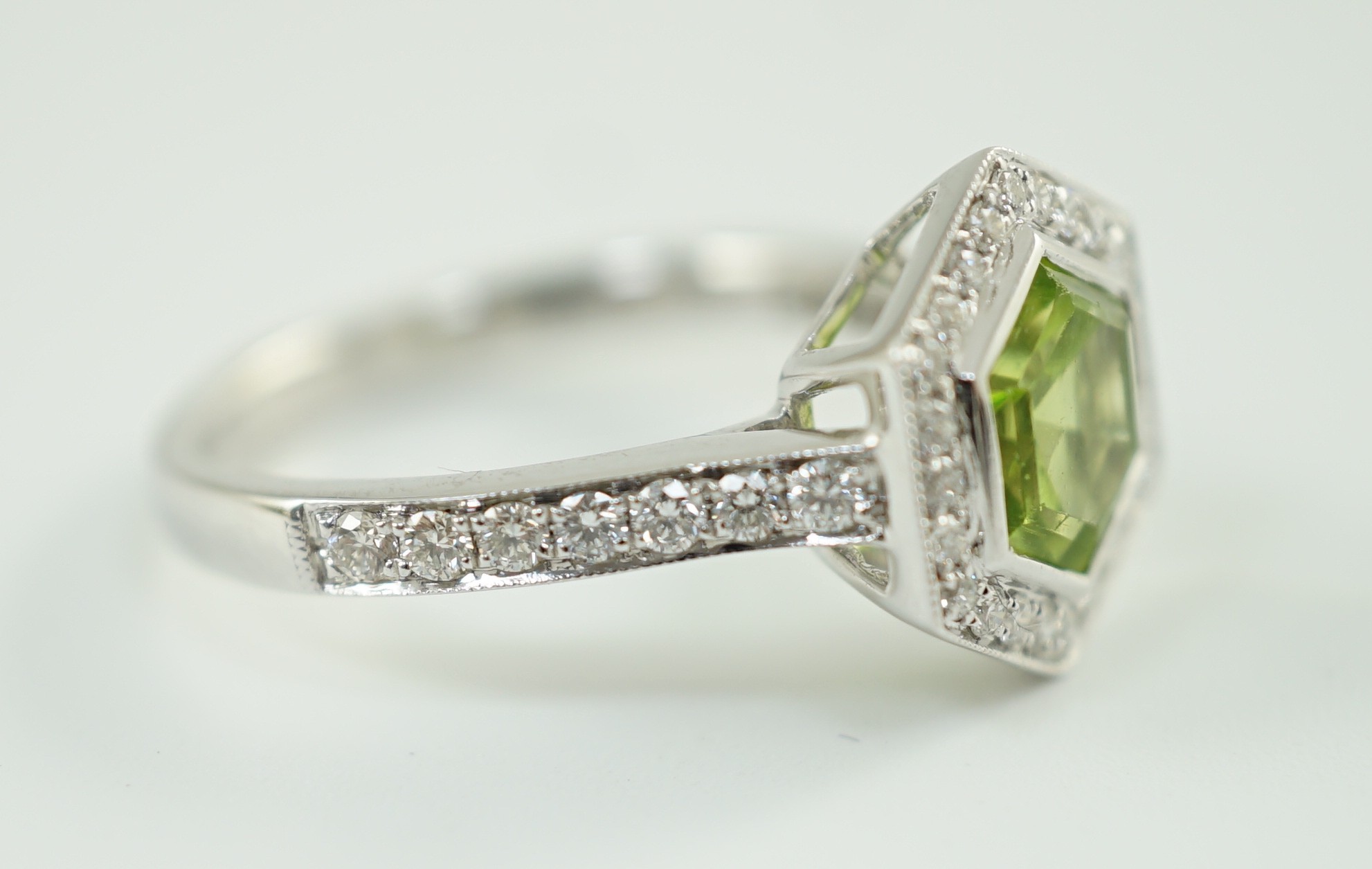 A modern 18ct white gold, peridot and diamond set hexagonal cluster set dress ring